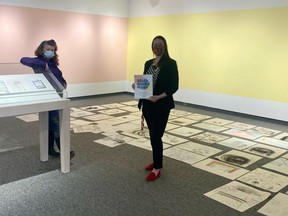 Heather McLeese, right, the Tom Thomson Art Gallery's curator of public projects and education, and Durham artist JP Morel stand among submissions from area youth Saturday that will guide the creation of a #myessential collaborative mural project at the Owen Sound gallery. Morel will be painting the mural over the next couple of weeks on the walls of The Jennings David Young Gallery space, which the pair is standing in. DENIS LANGLOIS