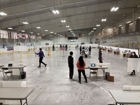 Kingston, Frontenac and Lennox and Addington Public Health staff prepare to receive the first-ever visitors to Kingston's COVID-19 vaccination clinic at the Invista Centre on Monday. The clinic was set to open that day at 4 p.m.