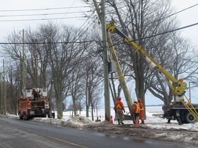 Utilities Kingston workers install new poles along King Street.