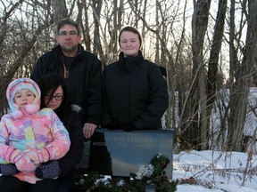 The Garrah family — Maria, Lori, John and Dawn — at Deidra’s grave at St. Patrick’s Cemetery in Sydenham, on Thursday.