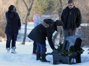 The Garrah family, Lori, Maria, Dawn and John, at Deidra Garrah’s grave at St. Patrick’s Cemetery in Sydenham on Thursday.