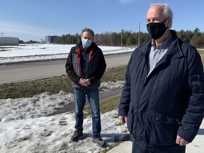 Paul Hartwick, right, and Loyalist-Cataraqui District Coun. Simon Chapelle stand outside the Canada Royal Milk plant, which has been emanating an unpleasant odour lately, on Tuesday.