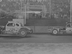 Norm Davey (Z28), Kingston Speedway track champion in 1974, holds off Dave Heaslip down the front straightaway.