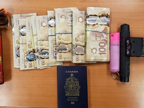 A conducted energy device, bear spray, a passport and approximately $39,000 cash were seized by Ontario Provincial Police on Wednesday in Napanee.