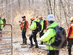Search and rescue volunteers are seen in the woods along Canoe Lake Road, as part of the search party looking for three-year-old Jude Walter Leyton, who has been missing since late Sunday morning, north east of Verona, on Monday.
