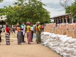 Women wait in line during a United Nations World Food Program distribution at the "3 de fevereiro escola" school in Matuge district, northern Mozambique, on Feb. 24, 2021.