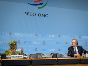 New director-general of the World Trade Organization, Ngozi Okonjo-Iweala, left, speaks with chair of the WTO General Council Ambassador David Walker during a session at the WTO headquarters in Geneva on March 1.