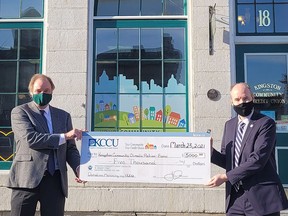 Jon Dessau, CEO of the Kingston Community Credit Union, presents a cheque to Kingston Mayor Bryan Paterson to be added to the city's Kingston Community Climate Action Fund on Tuesday.