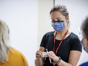 Queen's University medical student Tania Yavorska prepares to administer a COVID-19 vaccination to a Kingston Health Sciences Centre staff member at a Queen's School of Medicine student-run vaccination clinic in an undated file photo.