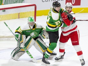 Kirill Steklov of the London Knights battles with Tye Kartye of the Soo Greyhounds in front of Knights goalie Brett Brochu during the first period of their game on Feb. 28, 2020 in London. (Derek Ruttan/The London Free Press)