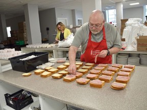 Owen Sound Hunger and Relief Effort board member Pat McDonough prepares lunches along with executive director Colleen Trask Seaman in downtown Owen Sound in this photo from May.