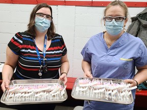 Tina Davidson (left), chief pharmacist at the Pembroke Regional Hospital, and Grace Weisenberg, pharmacy manager, prepared trays of syringes filled with doses of COVID-19 vaccine for the first public vaccination clinic at the Pembroke Memorial Centre March 12.