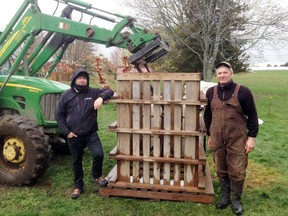 Thierry Raimbault (left), environmental co-ordinator for the MRC Pontiac, and Lynn Leavitt, a beef producer from Picton, Ont. show off the Pac-It press, which Leavitt designed.