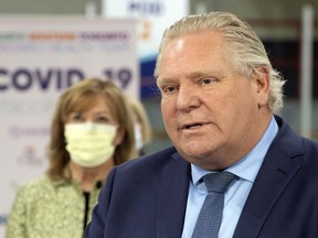 Ontario Premier Doug Ford is expected to announce further COVID-19 restrictions for some areas of the province on Thursday, ahead of the Easter long week. He is seen here speaking during the daily briefing at a mass vaccination centre in Toronto on Tuesday, March 30.