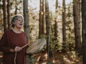 One of the photos that lead photographer Maureen MacMillan took for the Honouring Seniors Creative Photography project, showing Roberta Della Picca, drumming and singing in the woods beside her home (pictured). The project was advertised on the South Algonquin township Facebook page March 16 to get seniors in the township to participate in it. It was conceived of, organized and coordinated by MacMillan and Ottawa Valley Community Arts' Anya Gansterer.