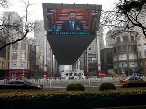A giant screen shows Chinese President Xi Jinping attending the opening session of the National People's Congress (NPC) at the Great Hall of the People, in Beijing, China, on March 5, 2021.