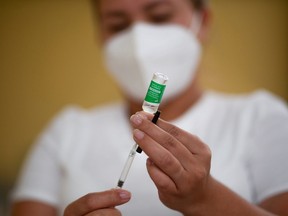 A health worker prepares a dose of the Oxford-AstraZeneca coronavirus disease (COVID-19) vaccine, marketed by the Serum Institute of India (SII) as COVISHIELD, in Guatemala City, Guatemala on March 10, 2021. REUTERS/Luis Echeverria ORG XMIT: GDN