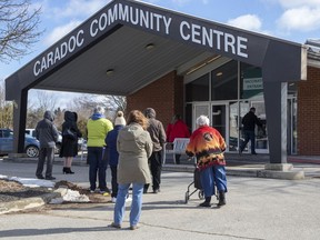 People line up outside the vaccination clinic at Caradoc Community Centre in Mt. Brydges, Ont. on Friday March 5, 2021. Derek Ruttan/Postmedia Network