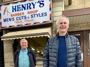 Brothers Matthew, front, and Frank Willemsen are retiring from Henry’s barber shop on Downie Street after 50 years in business. Their father, Henry, opened the shop across the street in 1960. It’s become a popular spot over the years; multiple people honked as they drove by this photo, some offering congratulations on their retirement. (Cory Smith/Stratford Beacon Herald)