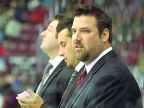 Bobby Jones, with D.J. Smith and Bob Boughner, behind the bench of the Windsor Spitfires. POSTMEDIA