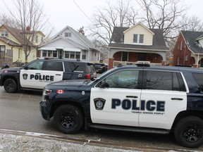 Police vehicles are shown Thursday outside a home on Talfourd Street in Sarnia were it's alleged two women were assaulted. A Sarnia man has been arrested and its facing charges.