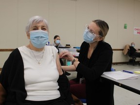Helen Marcy, 94, of Sarnia was first in line Saturday for a COVID-19 vaccine shot at the Point Edward Arena. RPN Jessica Henderson administered the shot. Vaccine clinics began Saturday for Lambton County residents over the age of 90.