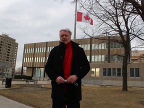 Sarnia Mayor Mike Bradley stands Thursday at City Hall where the flag was lowered in commemoration of the one-year anniversary of the declaration of the pandemic. March 11 was declared a National Day of Observance in Canada by the federal government.