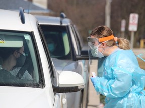 Amber Milley, with the Central Lambton Family Health Team, administers COVID-19 tests during a one-day drive-thru clinic held Wednesday in Forest. Demand has spiked recently at a standing rural testing clinic in Wyoming, an official said.