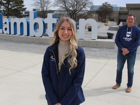 Andrea Dyck, president of the Lambton College Enactus team, and staff adviser Jon Milos are shown outside the Sarnia school's main building. The Sarnia Enactus team is heading back to the student organization's national competition after winning first place at a recent regional event.