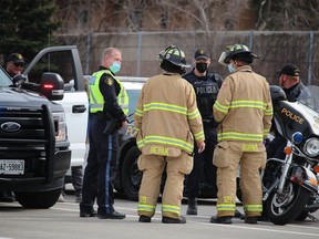 Police and firefighters are shown near where two transport trucks came into collision on March 23, 2021, on Highway 402 near Christina Street in Sarnia.  Drivers of both trucks were taken to hospital and a section of the westbound highway was closed.Paul Morden/The Observer