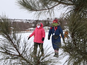 Friends take a stroll at Kivi Park in Sudbury, Ont. on Monday March 1, 2021.