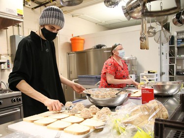 Prep cook David Blais, left, and kitchen manager Christine Newbury, of the Elgin Street Mission, prepare tuna sandwiches for supper for about 180 mission clients in Sudbury, Ont. on Thursday March 4, 2021. John Lappa/Sudbury Star/Postmedia Network