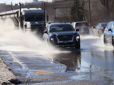 Motorists attempt to navigate through a large puddle on the Kingsway in Sudbury, Ont. on Thursday March 11, 2021. John Lappa/Sudbury Star/Postmedia Network