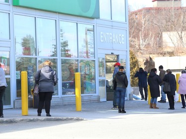 People line up to shop for groceries at Food Basics on Regent Street in Sudbury, Ont. on Friday March 12, 2021. John Lappa/Sudbury Star/Postmedia Network