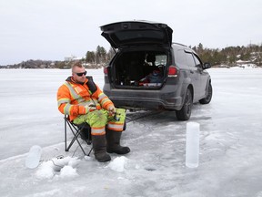 Pete Brown relaxes while ice fishing on Ramsey Lake in Sudbury, Ont. on Wednesday March 17, 2021. John Lappa/Sudbury Star/Postmedia Network