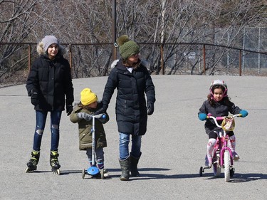 Cristina Beites, second right, gets some exercise with her children, Gaia, 13, Khush, 2, and Shavi, 5, at the Delki Dozzi track in Gatchell. Tuesday will be cloudy with a high of 14 degrees C. John Lappa/Sudbury Star/Postmedia Network