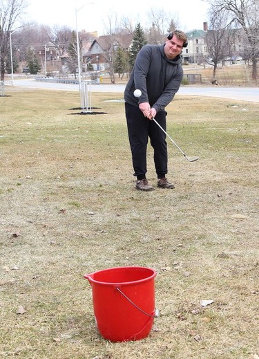 William Crichton, of Copper Cliff, Ont., works on his chip shot in the front yard of his home on Tuesday March 23, 2021. John Lappa/Sudbury Star/Postmedia Network