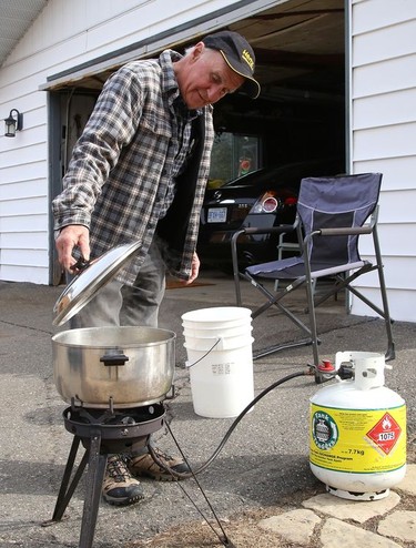 Daniel Boisvert, of Naughton, Ont., boils saps from a neighbour's maple tree so he can make maple syrup on Tuesday March 23, 2021. John Lappa/Sudbury Star/Postmedia Network