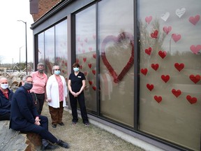 Staff of the Travelway Inn on Paris Street show off a display of hearts saluting the efforts of front-line health-care workers. The hotel has launched a Spread The Love campaign that invites other businesses, along with households and schools, to decorate their windows with similar tributes.