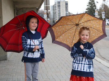 Dallas Fremlin, 6, and his sister, Blake, 4, had their umbrellas handy when it started to rain in Sudbury, Ont. on Wednesday March 24, 2021. John Lappa/Sudbury Star/Postmedia Network