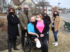 Bob Johnston, who recently had a second leg amputated, is surrounded by supporters Brenda Leroux, left, Rod Dunn, Carrie Wasylyk, Lydia Gaudreau and Chloe Arsenault at the Organ Donor park on Thursday. His friends and supporters are holding a number of fundraising events to help pay for Johnston's wheelchair, prosthesis and modifications that will have to be made to his vehicles.