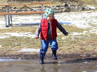 Two-year-old Nolan Sarazin has fun splashing in ice-covered puddles at Bell Park in Sudbury, Ont. Wednesday will be cloudy with a high of 3 degrees C. John Lappa/Sudbury Star/Postmedia Network
