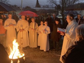 Father Daniele Muscolino leads the blessing of the fire at the Easter Vigil Mass at Holy Name of Jesus Church in North Bay in April 2019.