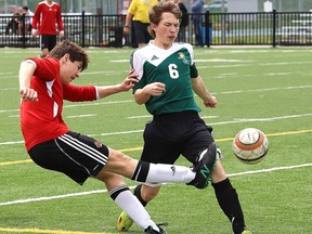 Alessio Capasso, left, of St. Charles Cardinals, fires the ball past Ethan Selk, of Confederation Chargers, during action at the junior boys high school soccer final at James Jerome Sports Complex in Sudbury, Ont. on Tuesday May 28, 2019. John Lappa/Sudbury Star/Postmedia Network