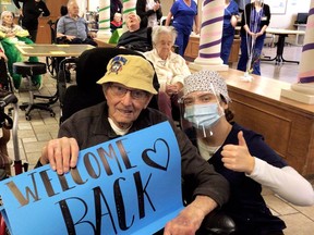 Everet Kraayenbrink (left) and Carly Johnston mark the end of a COVID-19 outbreak at Fairfield Park long-term care home in Wallaceburg on March 4. Handout