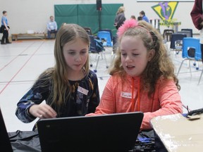 Elementary school students Ella Boisvert and Karsyn Gould take a crash course in coding at the Science Education Partnership's Science Discovery Squad presentation at Errol Road Public School in 2019. File photo/Postmedia Network