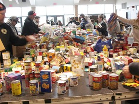 Volunteers sort Cyclone Aid food donations at St. Patrick's Catholic High School in Sarnia in this 2019 file photo. This year, organizers have switched to raising funds for the Inn of the Good Shepherd, instead of a food drive.