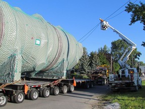 A Bluewater Power worker is shown in this file photo lifting lines for a large industrial vessel leaving Sarnia Harbour and beginning its trip through Sarnia to Chemical Valley. Work on a permanent oversized load corridor is progressing well, the project manager says. File photo/Postmedia Network