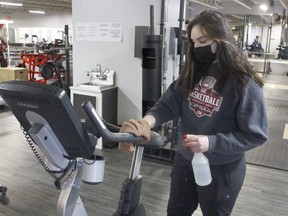 Abigail Couture, who works at Discover Fitness centre in Timmins, is seen sanitizing some of the equipment as most of the fitness centres have reopened locally while operating with new protocols and in some instances, a new layout. 

RICHA BHOSALE/The Daily Press