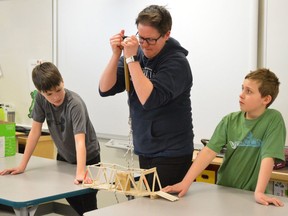 In this Daily Press file photo taken in March 2018, Grade 5 students at École publique Lionel-Gauthier watch carefully to test the strength of their 200-piece popsicle stick bridge. Owen Michaud, left, and Austin Moreau hold their bridge as Katelin Dzijacky, an engineer with Ontario Power Generation, puts more and more pressure on the structure. In previous years, the local engineering association hosted events to promote their profession to students. Due to the pandemic, however, those outreach program have been put on hold for a year,

The Daily Press file photo